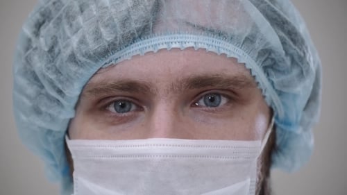 Medical Professional Puts on Safety Glasses in Close Up