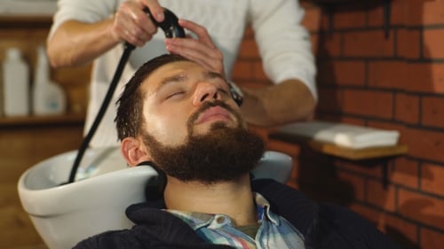 Hairstylist Washing Client's Hair in Barber Shop