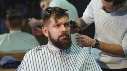 Confident Man Visiting Hairstylist in Barber Shop