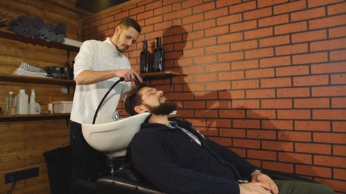 Hairstylist Washing Client's Hair in Barber Shop