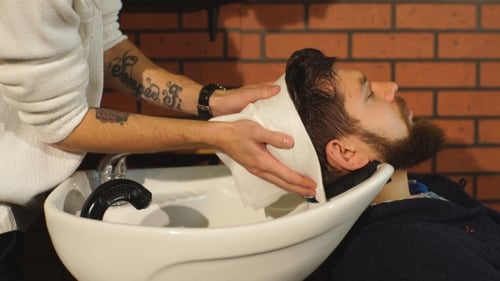 Hairstylist Washing Client's Hair in Barber Shop
