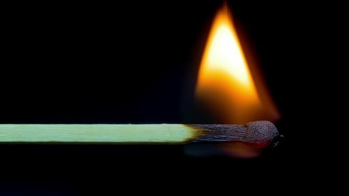 Burning Matchstick on Black Background Close Up