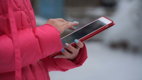 Footage Woman Using Tablet Outdoors in Winter