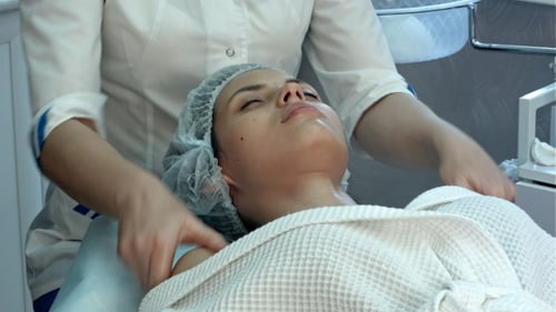 Young Woman at a Spa Getting Facial and Neck Massage
