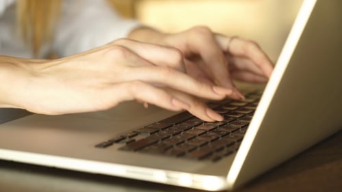 Woman Typing on Laptop Keyboard Close Up