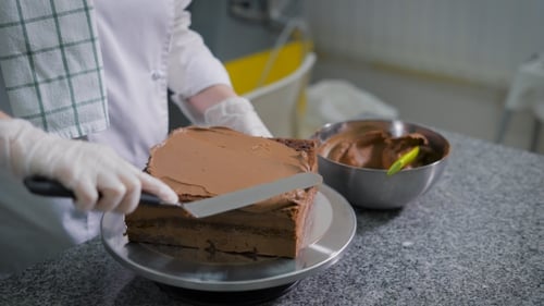 Chef Decorates Chocolate Cake with Chocolate Icing
