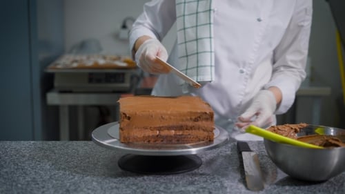 Chef Frosting a Delicious Chocolate Layer Cake
