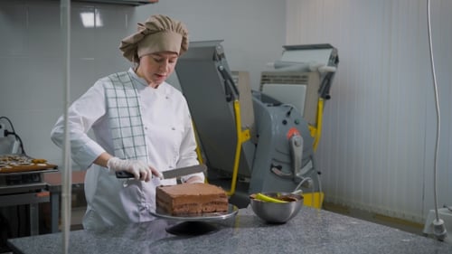 Pastry Chef Icing Cake in Commercial Kitchen