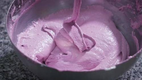 Cream Purple Color Slowly Drains Into the Pot for Cooking Sweets. Metal Bowl on a Table in a Bakery