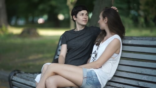 Two Girls Lesbians Relaxing in the Park on a Bench