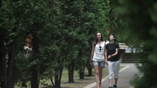Two Lesbians Holding Hands and Walking in the Park