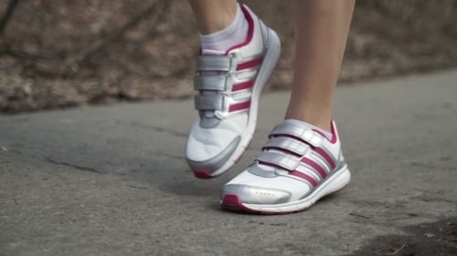 The Girl Athlete Stretching in the Park Before the Run