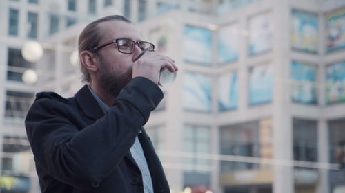 Man Drinking Coffee in an Urban Setting