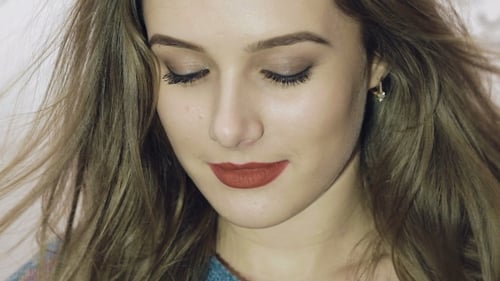 Young Woman with Flowing Hair Smiling at Camera