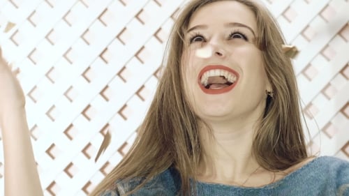 Woman Celebrates with Confetti at Birthday Party