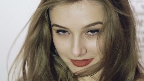 Smiling Woman with Long Hair in Studio Close Up