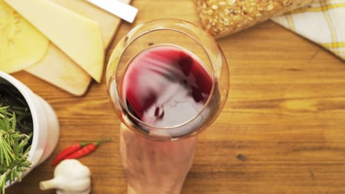 Hand Swirling Red Wine in Glass Overhead Shot