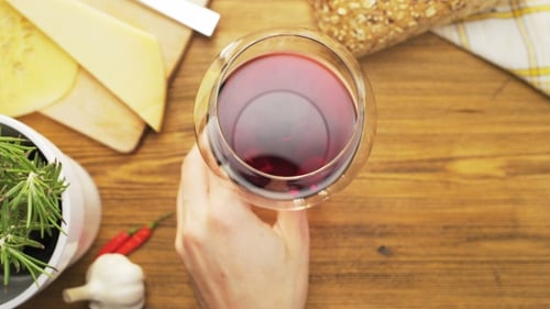 Swirling Red Wine with Cheese and Rustic Food