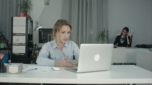 Woman Actively Engaged in Video Conference in Office