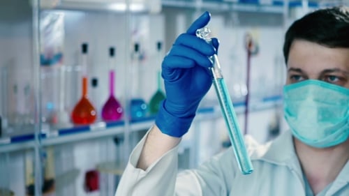 Scientist Examining Test Tube in Bright Laboratory