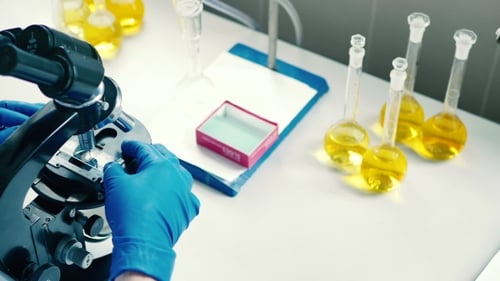 Scientist Using Microscope in Medical Laboratory