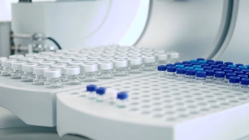 Laboratory Worker Puts Jars in Cells