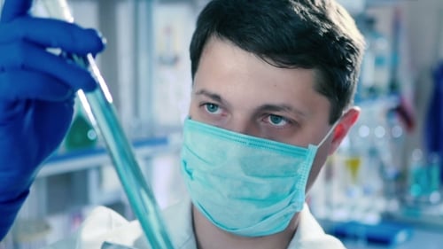 Laboratory Test Tube Turns in His Hands