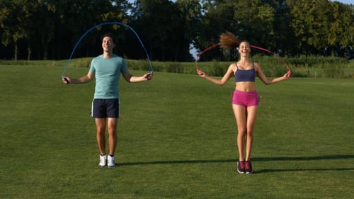 Couple Doing Jump Rope Exercise Outdoors Together