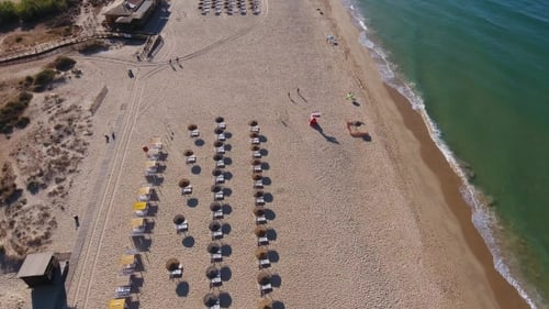 Flight Shooting Over the Beach Falesia with Tourists on Sunbeds on Holiday.