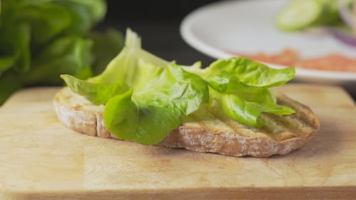 Open Faced Sandwich Being Prepared on Wooden Board