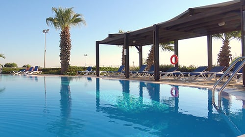 Swimming Pool And Lounge Chairs At Resort