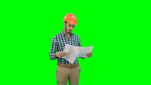 Engineer in Hardhat Looking at Construction Plan