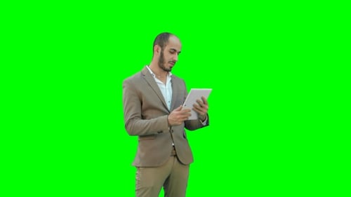 Man in Suit Using Tablet on Green Screen