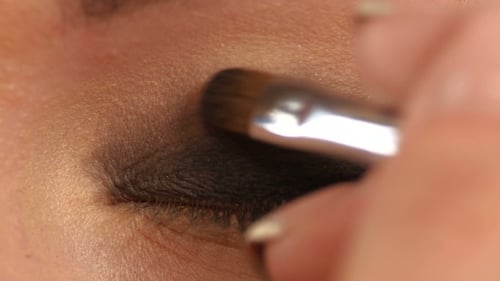 Make-Up Artist Applying Bright Base Color Eyeshadow on Model's Eye