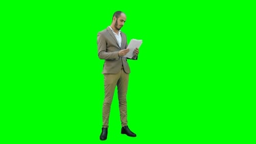 Man Reading Documents Wearing Suit on Green Screen