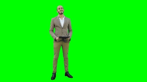 Happy Young Man Making Business Presentation on a Green Screen, Chroma Key.