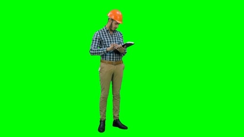 Site Inspector Filing in Inspection Form on a Green Screen, Chroma Key
