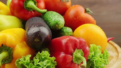 Fresh Vegetables Rotating on a Wood Platter
