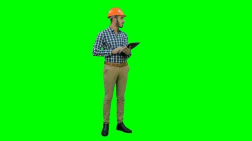 Engineer in Helmet Inspecting Construction Site on a Green Screen, Chroma Key.