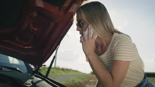 Woman Calling For Assistance Next To Broken Down Car