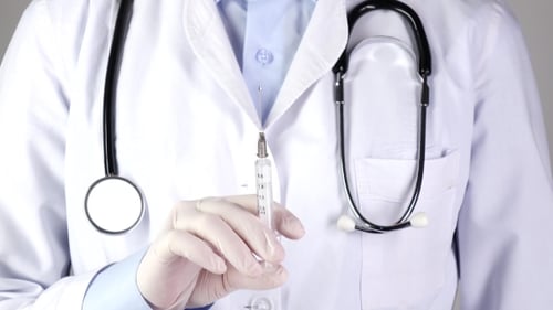 Doctor in Medical Gloves Holding Syringe and Stethoscope, on White