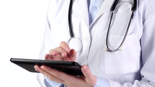 Doctor Standing and Holding Tablet Compute, Wearing Stethoscope, on White