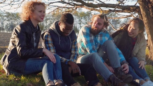 Four Multiracial Friends Sitting at Rural Area.