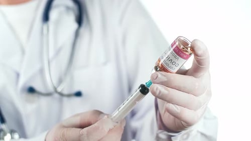 Doctor Draws COVID Vaccine into Syringe