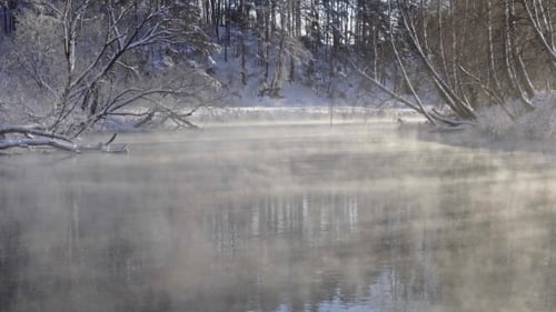 Fog Flowing Over a River in Winter