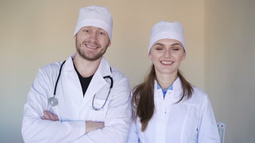 Two Smiling Medical Professionals in White Coats