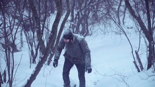 Man Climbing Up Snowy Hill