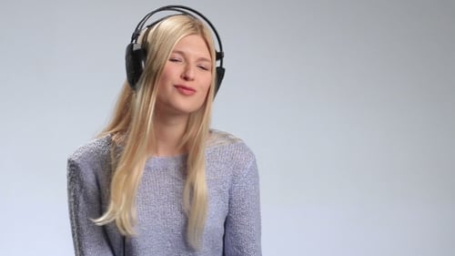 Woman Enjoying Music with Headphones in Studio