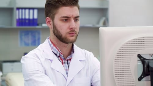 Young Adult Man Working in Medical Laboratory
