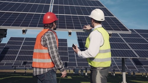 Engineers Discuss Solar Power at Solar Panel Farm